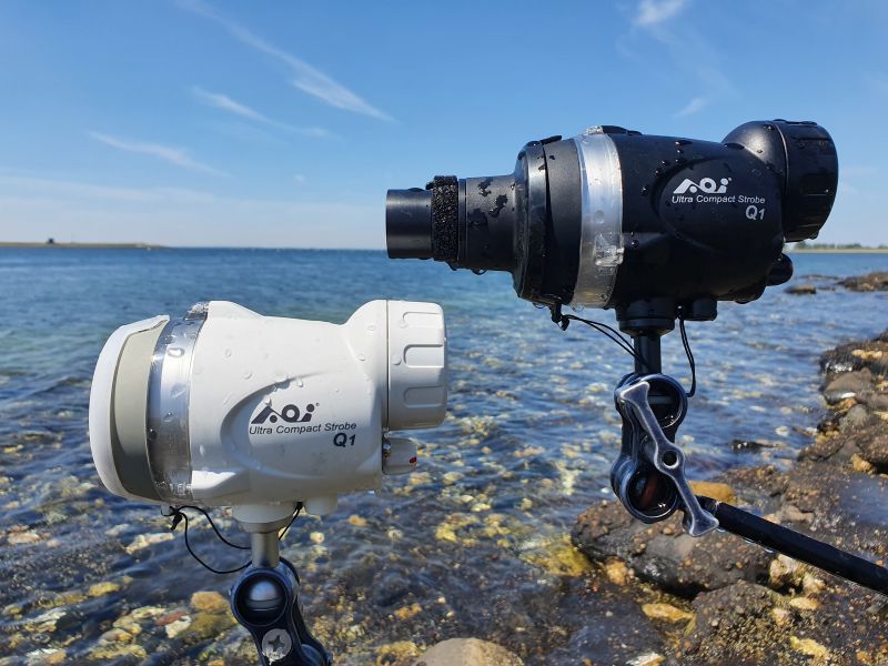 Compact underwater camera paired with a strobe light for enhanced photography